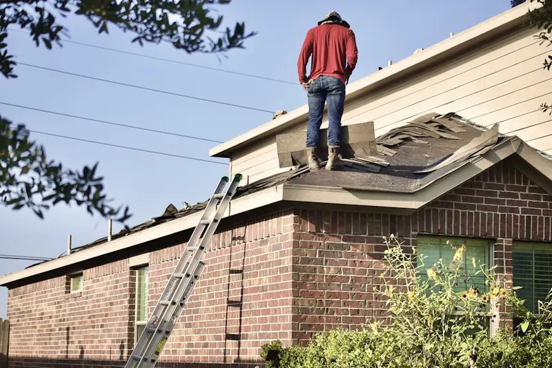 Professional roofer working on a residential roof in Mission Green North